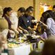 Families walk up to be served a meal at the 9th ACC Annual Thanksgiving potluck, Nov. 24